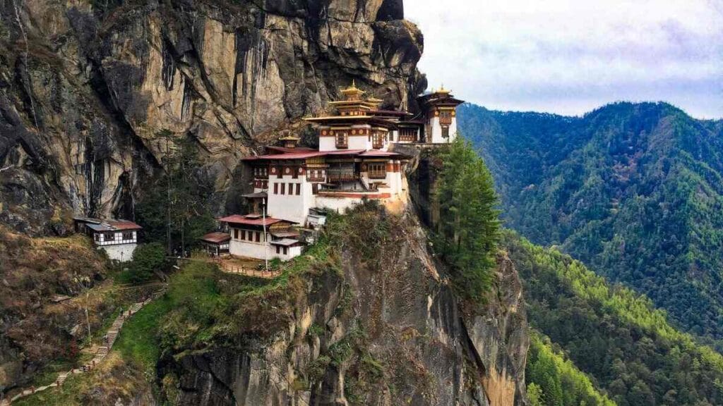 1 White, black, and brown house beside moutantiasn - bhutan