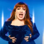 CMAT performing ‘Take A Sexy Picture Of Me’ in a blue velvet outfit with backup dancers and dynamic lighting.