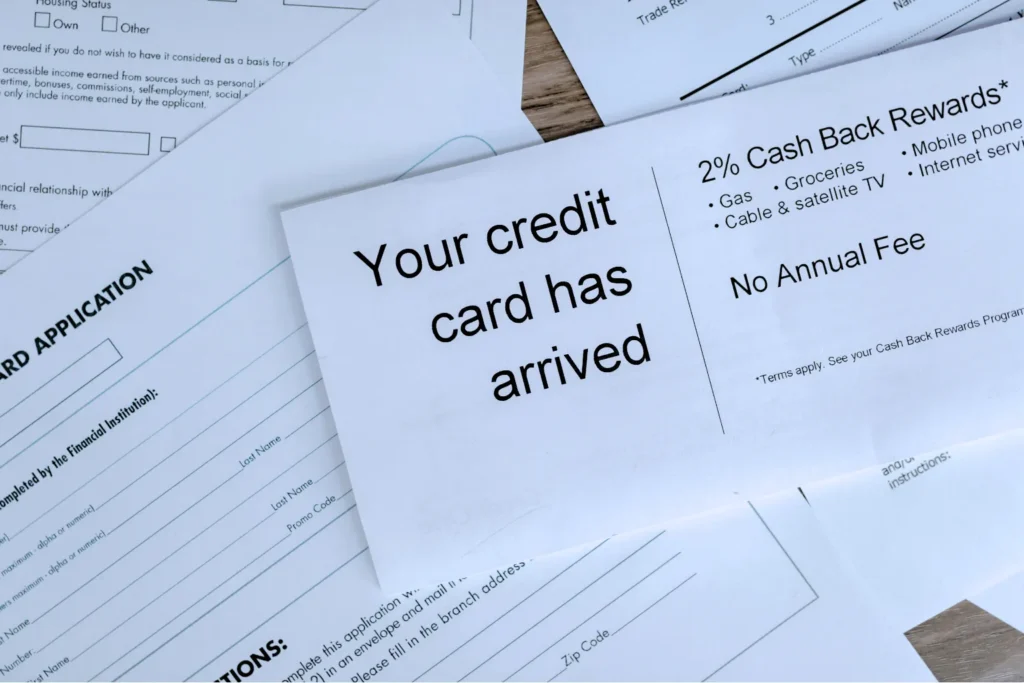 A credit card approval letter over application forms, promoting best credit cards in India 2026 and no annual fees.